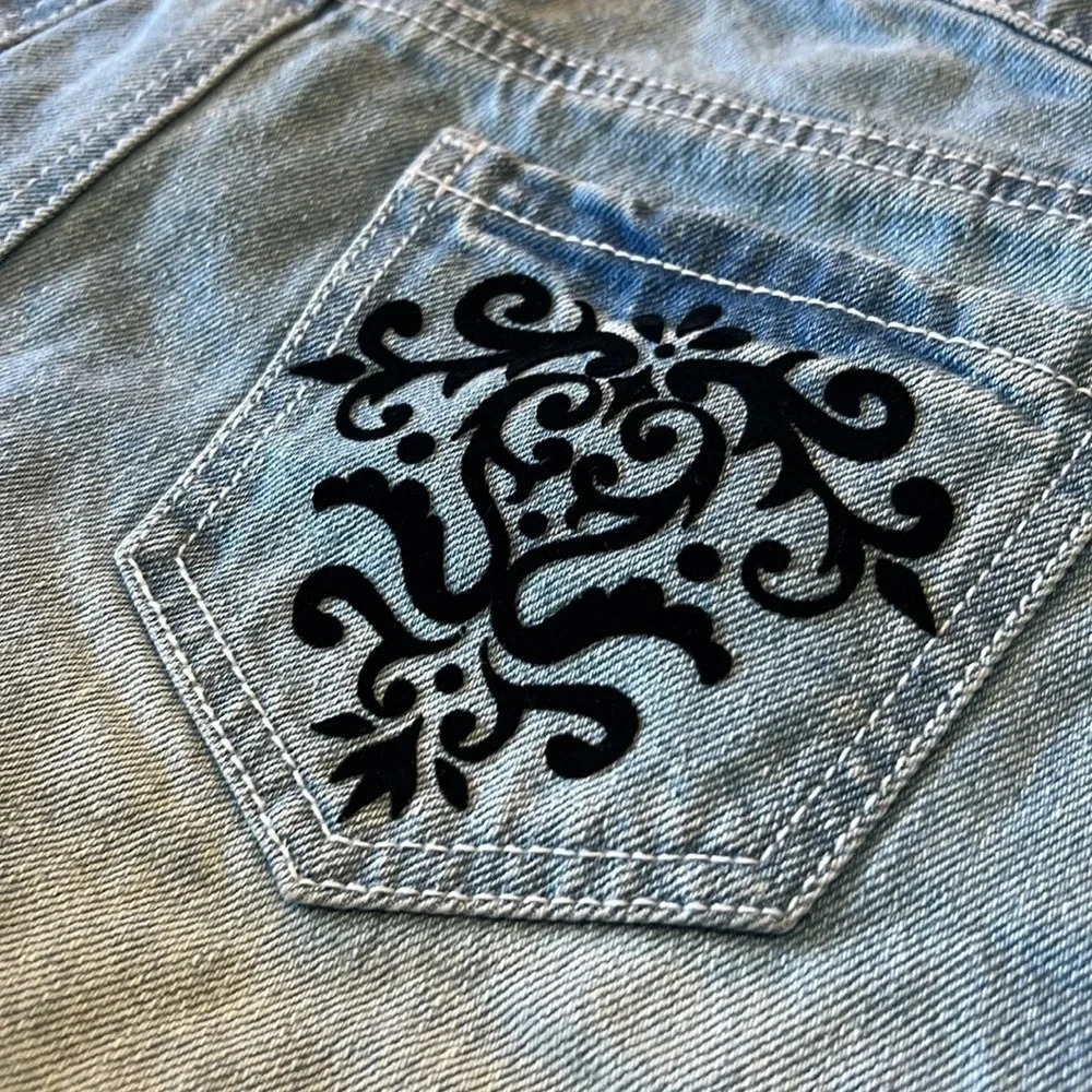 Material Girl light wash jean shorts with black velvet embellishments. Size 7 - Picture 6 of 9